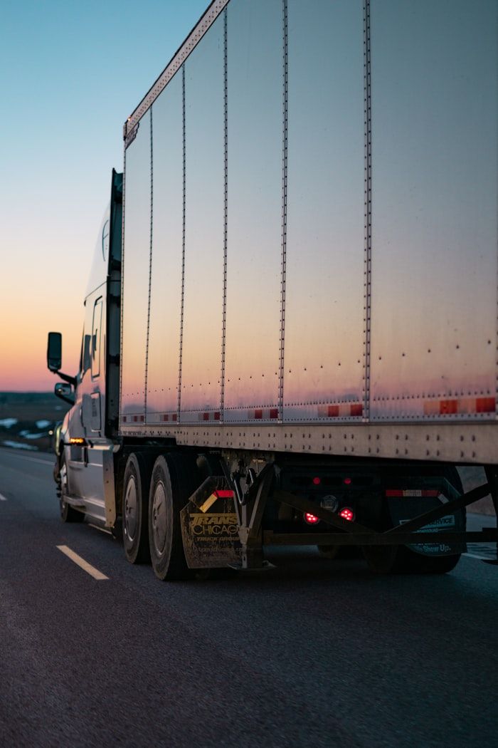 Semi truck on the highway at sunset